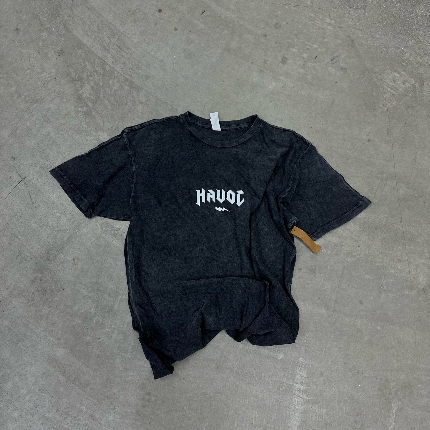 BLACK VINTAGE WASH TEE WITH THE WORD HAVOC ACROSS THE MIDDLE WITH A LIGHTENING BOLT. GRAPHIC IS ALL WHITE