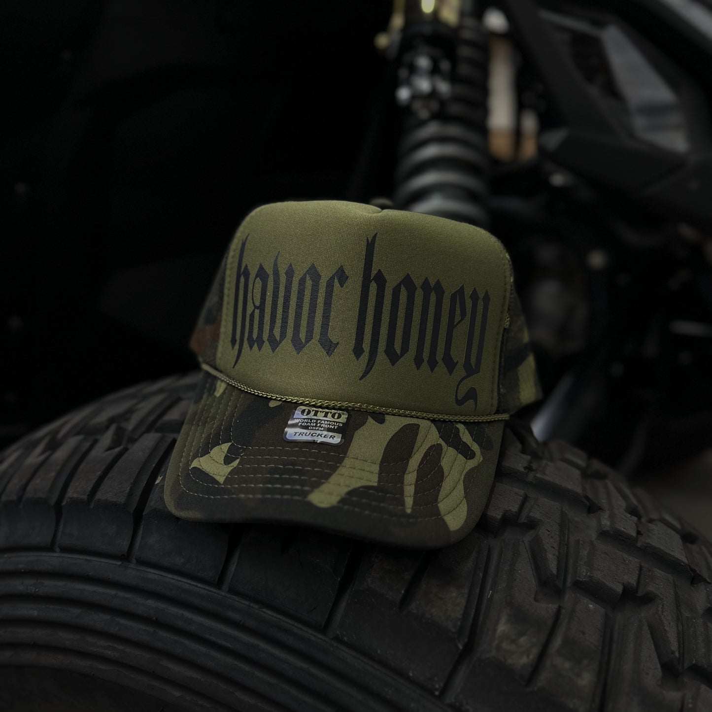 CAMO TRUCKER HAT THAT SAYS HAVOC HONEY IN BLACK